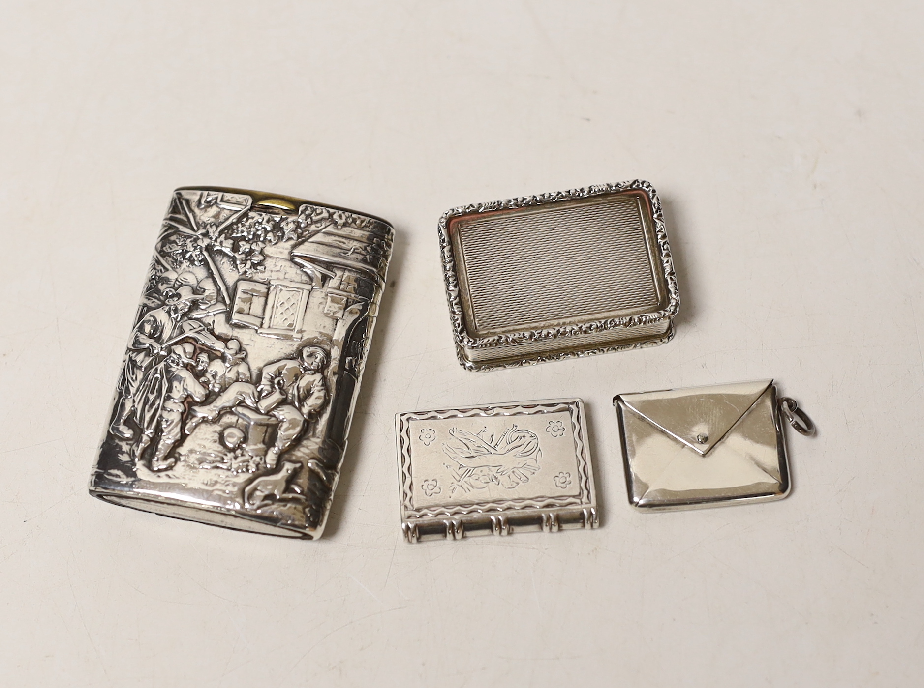 A modern silver snuff box, an Edwardian silver 'envelope' stamp case, a German 925 snuff box and an unusual antique white metal spinning fob seal case?
